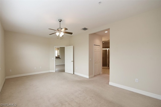 carpeted spare room with ceiling fan