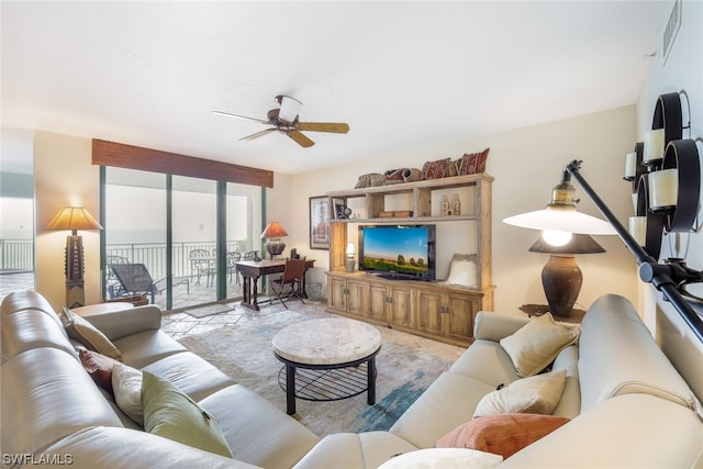 living room featuring a water view and ceiling fan