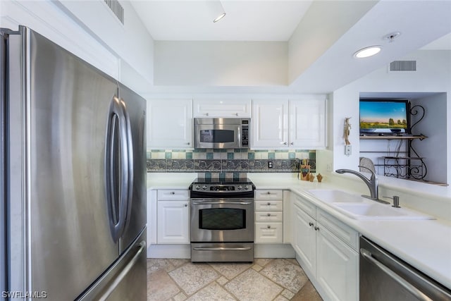 kitchen with sink, light tile floors, stainless steel appliances, tasteful backsplash, and white cabinetry