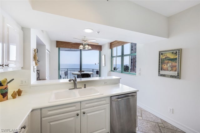 kitchen featuring sink, ceiling fan, white cabinets, dishwasher, and a water view