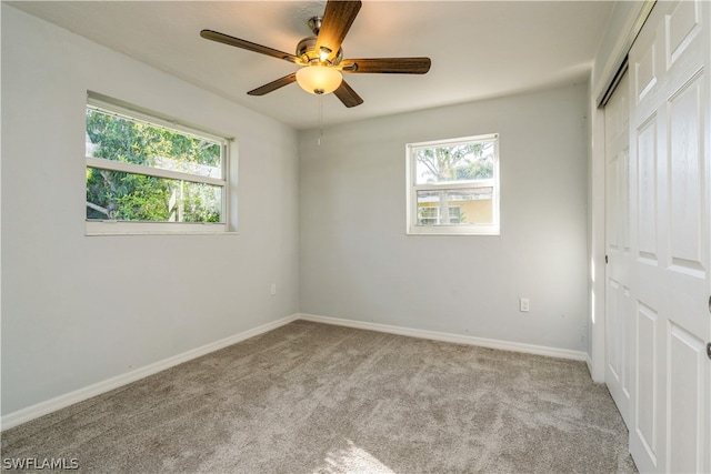 unfurnished bedroom with a closet, light carpet, and ceiling fan