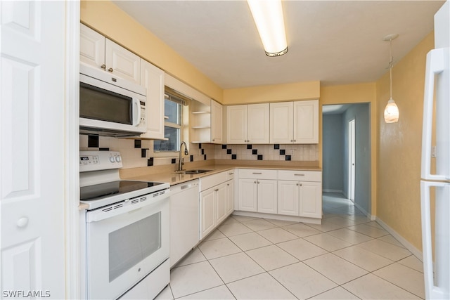 kitchen featuring tasteful backsplash, white appliances, and white cabinets