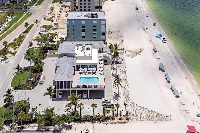 bird's eye view with a water view and a beach view