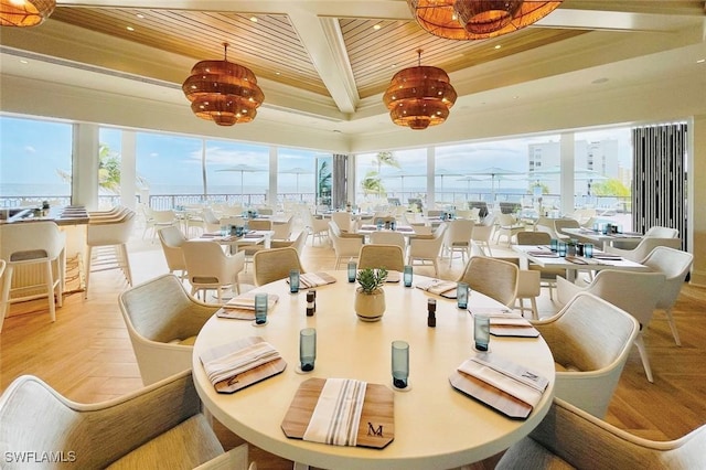 dining space featuring a raised ceiling, crown molding, and wood ceiling