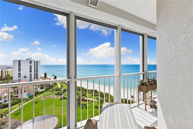 sunroom / solarium featuring a water view