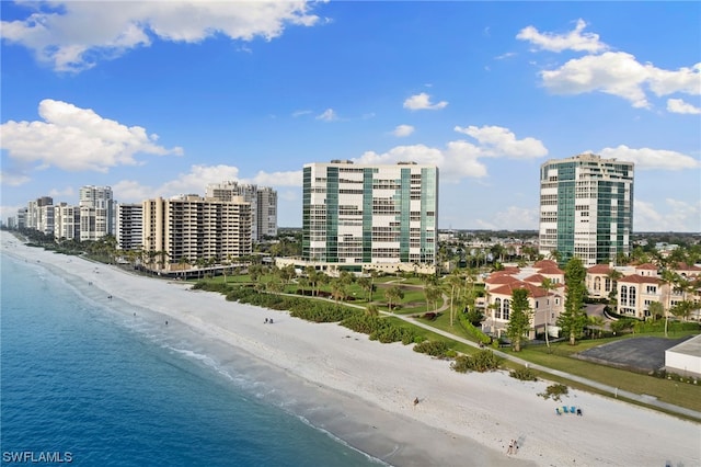 bird's eye view featuring a water view and a beach view