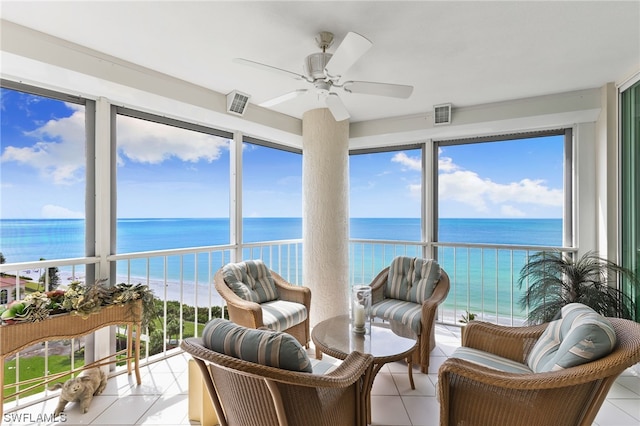 sunroom / solarium with a water view, ceiling fan, and plenty of natural light