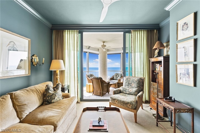 carpeted living room featuring a water view, ceiling fan, and crown molding