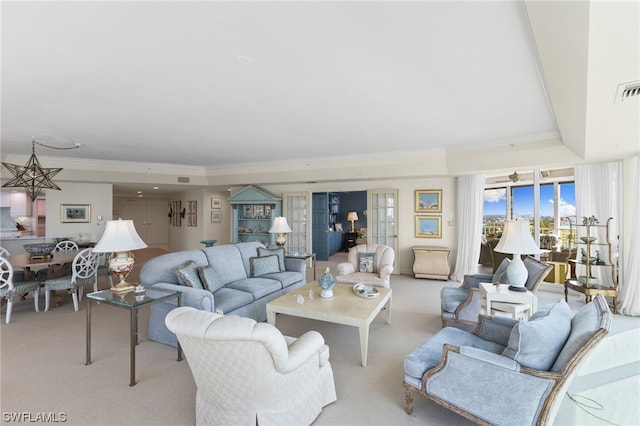 living room with light carpet, crown molding, and a tray ceiling