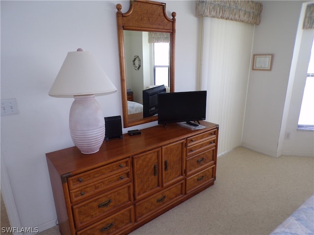 carpeted bedroom featuring multiple windows