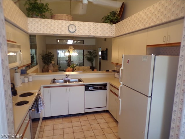 kitchen featuring sink, white appliances, light tile flooring, white cabinetry, and pendant lighting