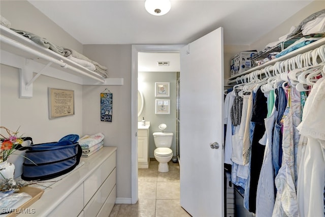 spacious closet featuring light tile patterned floors