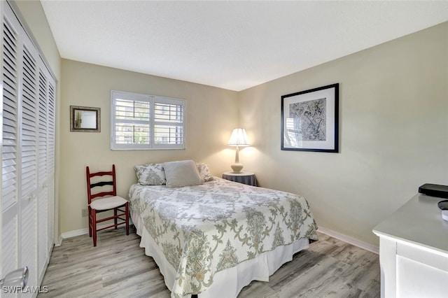 bedroom featuring light hardwood / wood-style flooring and a closet