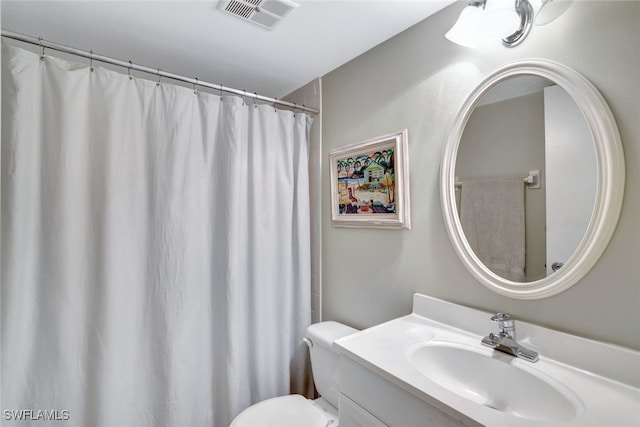 bathroom with toilet and vanity