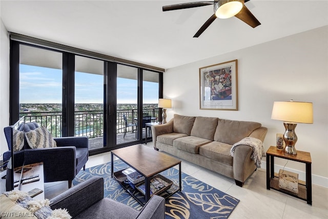 living room featuring ceiling fan, french doors, a wall of windows, and light tile floors