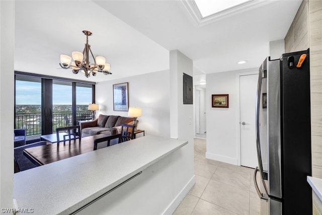 kitchen featuring light tile patterned flooring, decorative light fixtures, stainless steel fridge, a chandelier, and electric panel