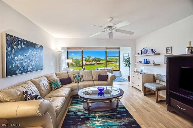 living room with light hardwood / wood-style floors and ceiling fan