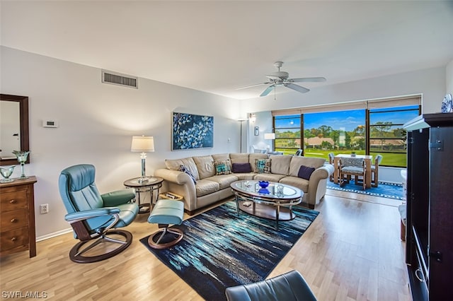 living room featuring ceiling fan and light hardwood / wood-style flooring