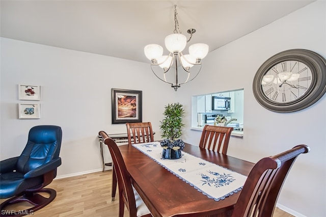 dining space featuring a chandelier and light wood-type flooring