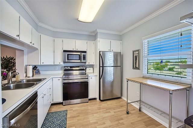 kitchen with white cabinets, appliances with stainless steel finishes, and light wood-type flooring