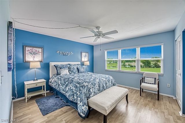 bedroom featuring a closet, ceiling fan, and light wood-type flooring