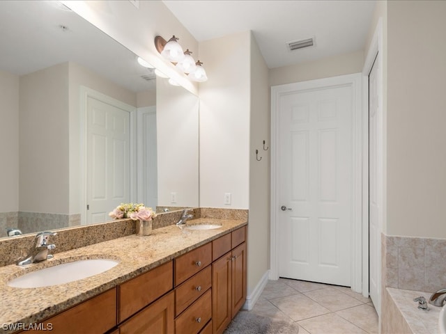 bathroom featuring tile flooring, vanity with extensive cabinet space, double sink, and tiled bath