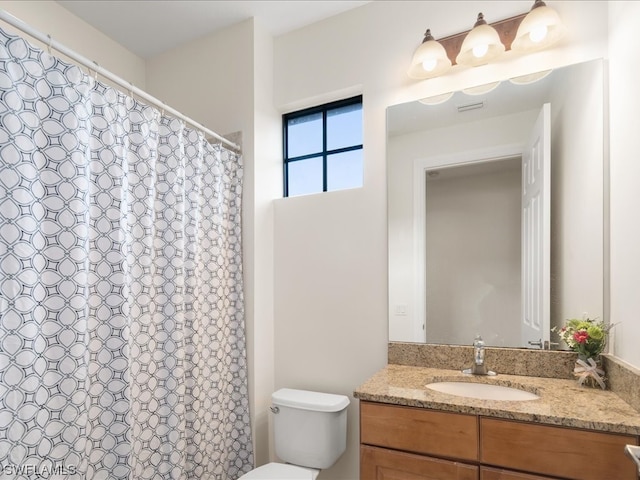 bathroom featuring toilet and large vanity