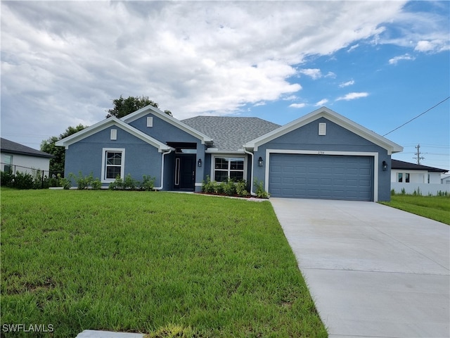 view of front facade with a front yard and a garage