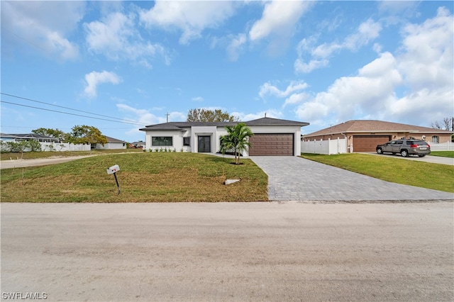 view of front of house featuring a front yard and a garage