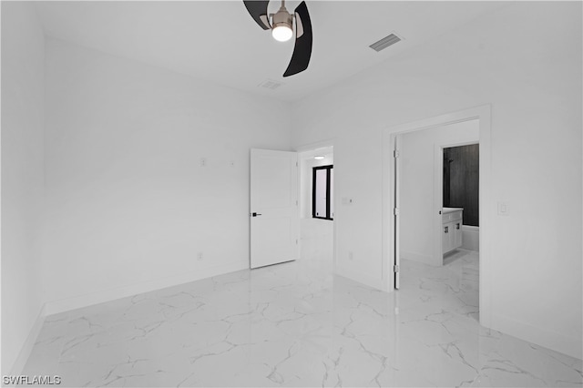 spare room featuring light tile floors and ceiling fan