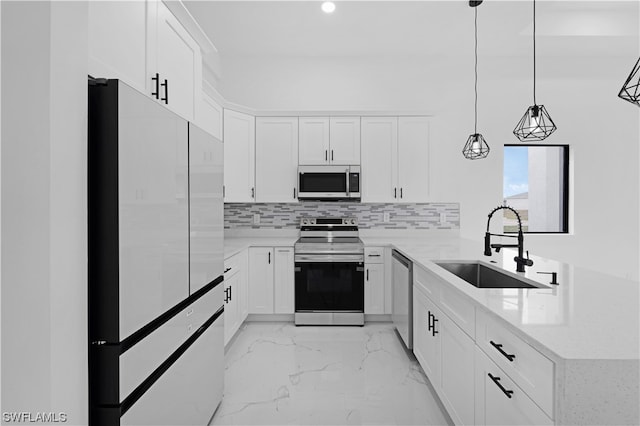 kitchen with pendant lighting, stainless steel appliances, white cabinets, backsplash, and sink