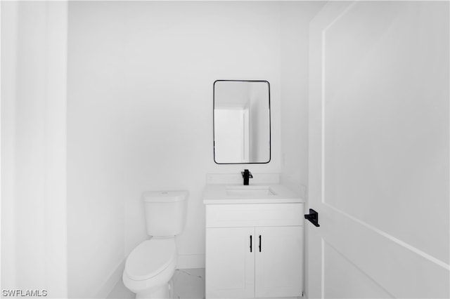 bathroom featuring toilet and vanity