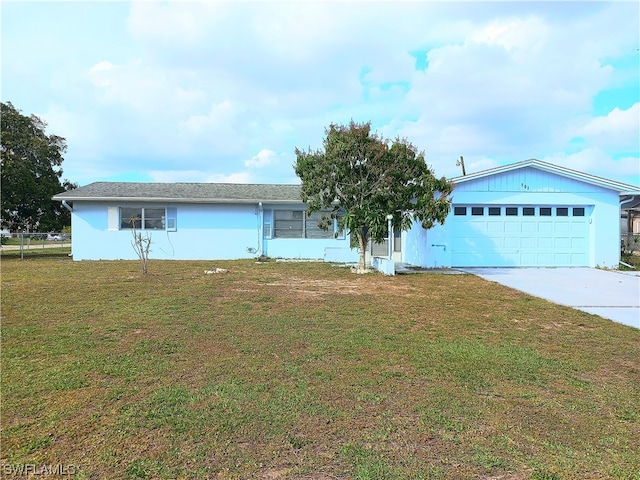 ranch-style house featuring a front lawn and a garage