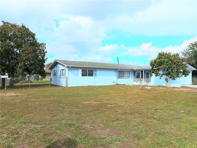 rear view of house with a yard