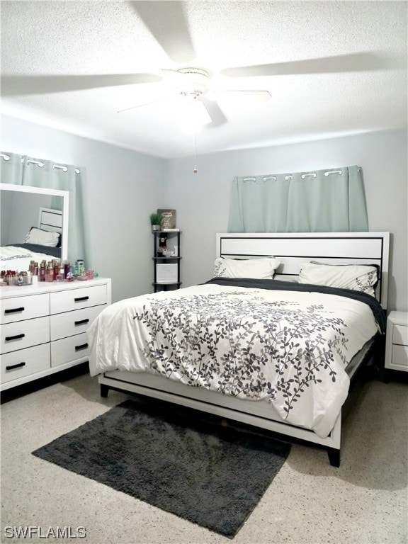 bedroom with a textured ceiling and ceiling fan