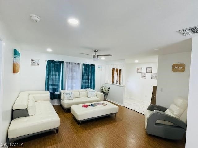 tiled living room with ceiling fan