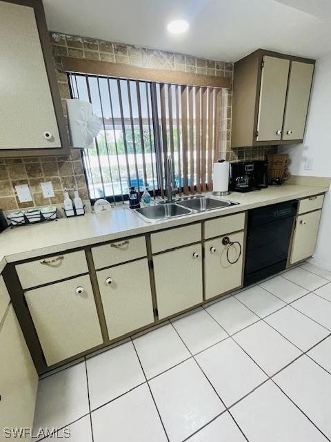 kitchen featuring light tile floors, backsplash, dishwasher, and sink