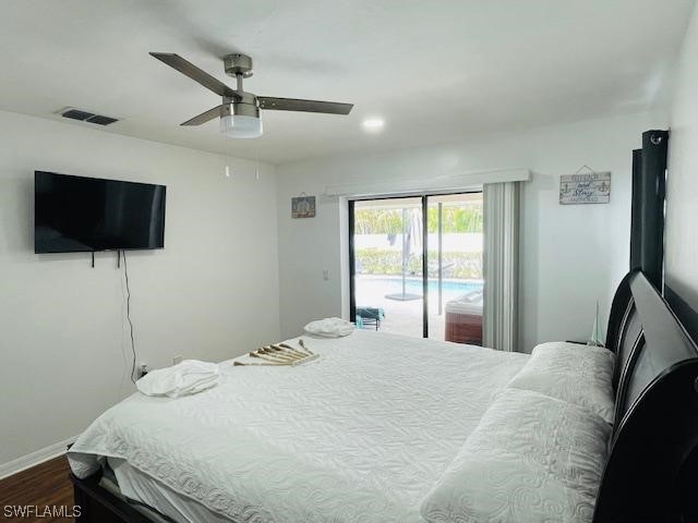 bedroom featuring dark hardwood / wood-style flooring, ceiling fan, and access to outside