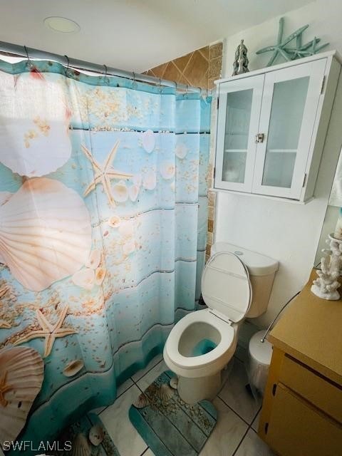 bathroom featuring toilet, tile floors, and vanity