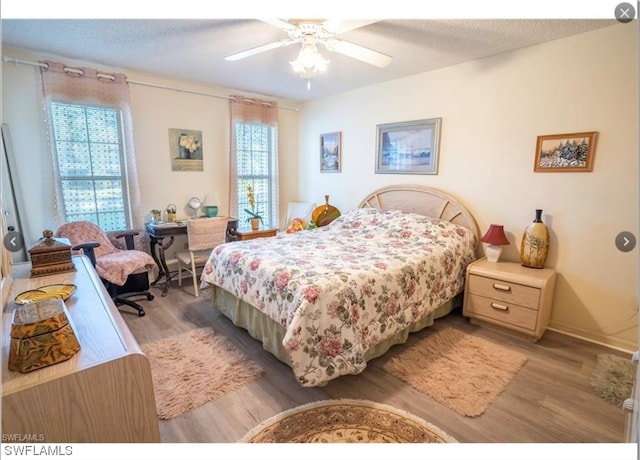 bedroom with wood-type flooring and ceiling fan