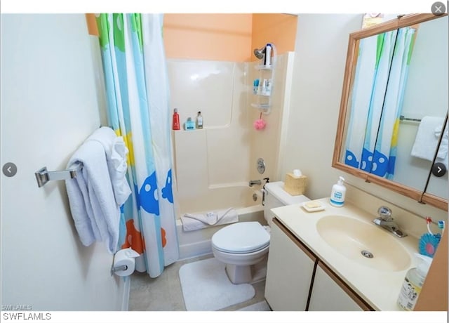 full bathroom featuring shower / bath combination with curtain, vanity with extensive cabinet space, tile floors, and toilet