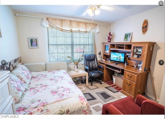 bedroom featuring a textured ceiling and ceiling fan