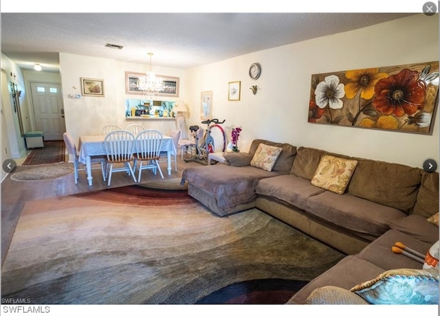 living room with hardwood / wood-style floors and a chandelier