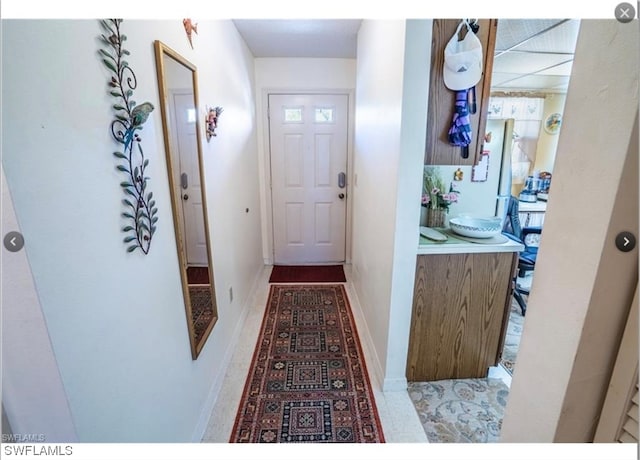 corridor featuring light tile floors