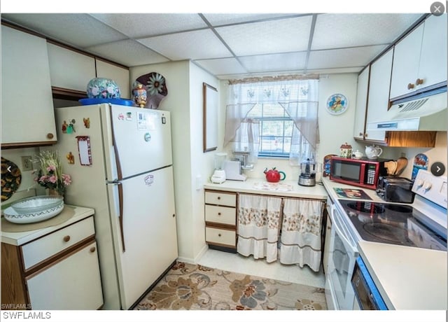 kitchen featuring white cabinetry, white appliances, and a drop ceiling