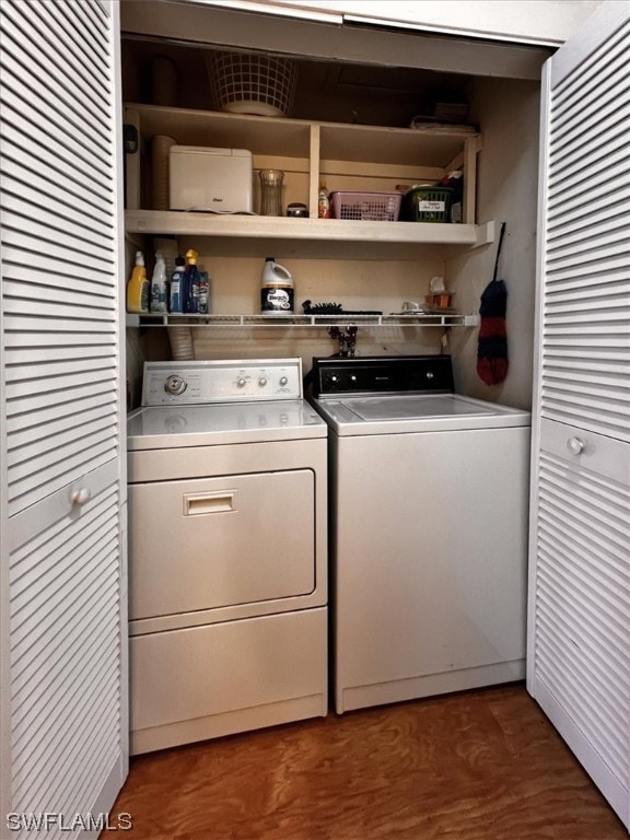 washroom with washing machine and clothes dryer and wood-type flooring