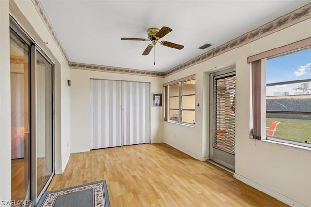 unfurnished room with ceiling fan, plenty of natural light, and light hardwood / wood-style floors