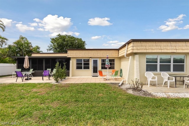 back of house featuring a patio and a lawn