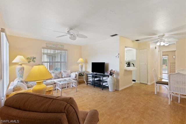 living room featuring ceiling fan and light hardwood / wood-style flooring