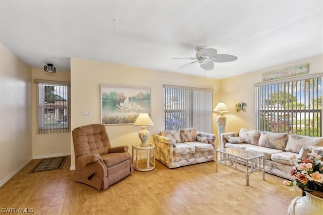 living room with ceiling fan and light wood-type flooring